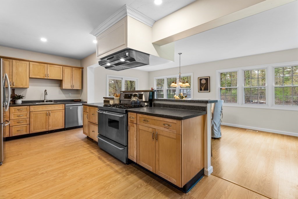55 Hickory Road Sudbury, MA 01776 - Photo 8 of 42 a kitchen with stainless steel appliances granite countertop a stove a sink and a refrigerator