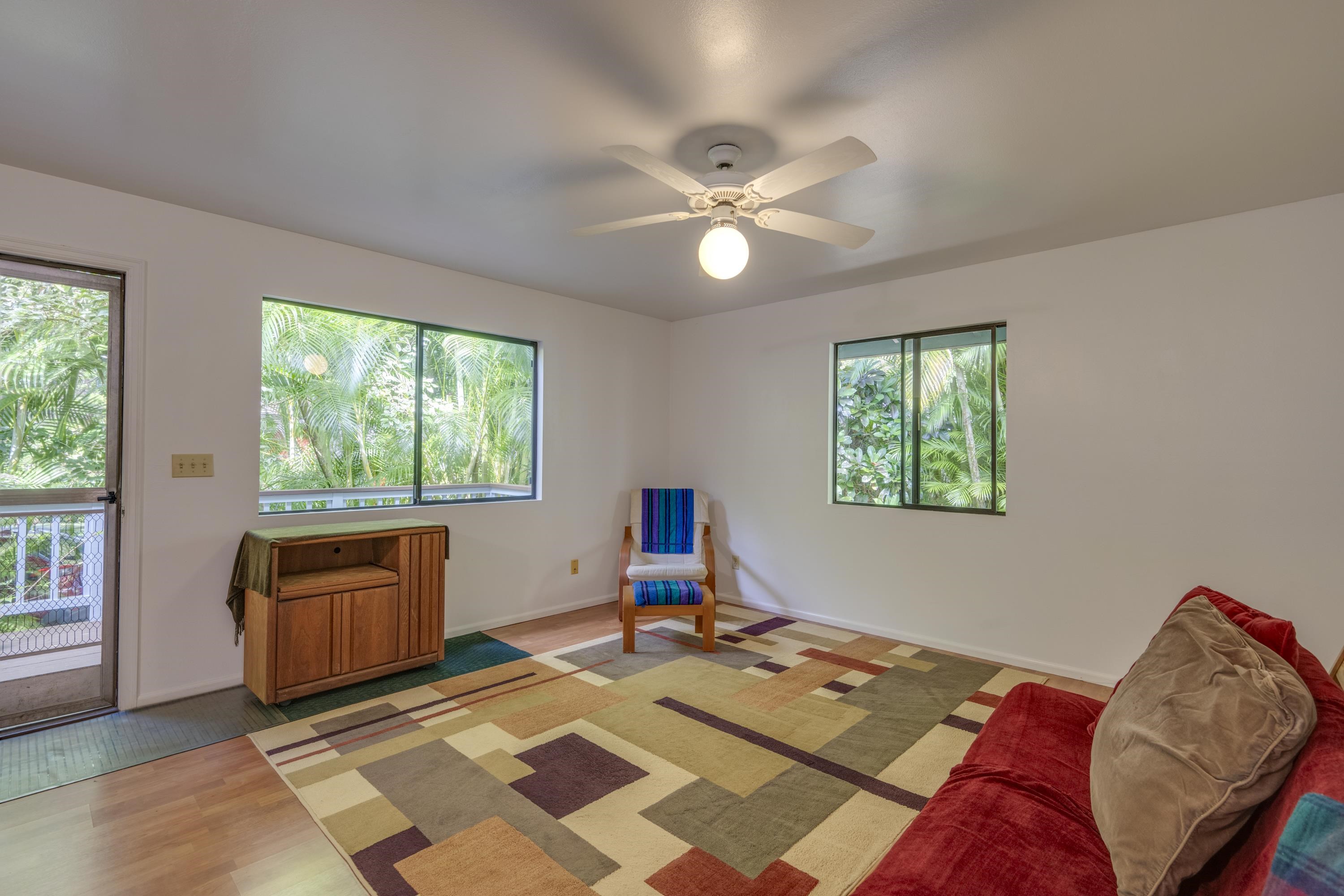 1002 Kauhikoa Road, Unit 2 Haiku, HI 96708 - Photo 13 of 24 a bed room with a bed and a window