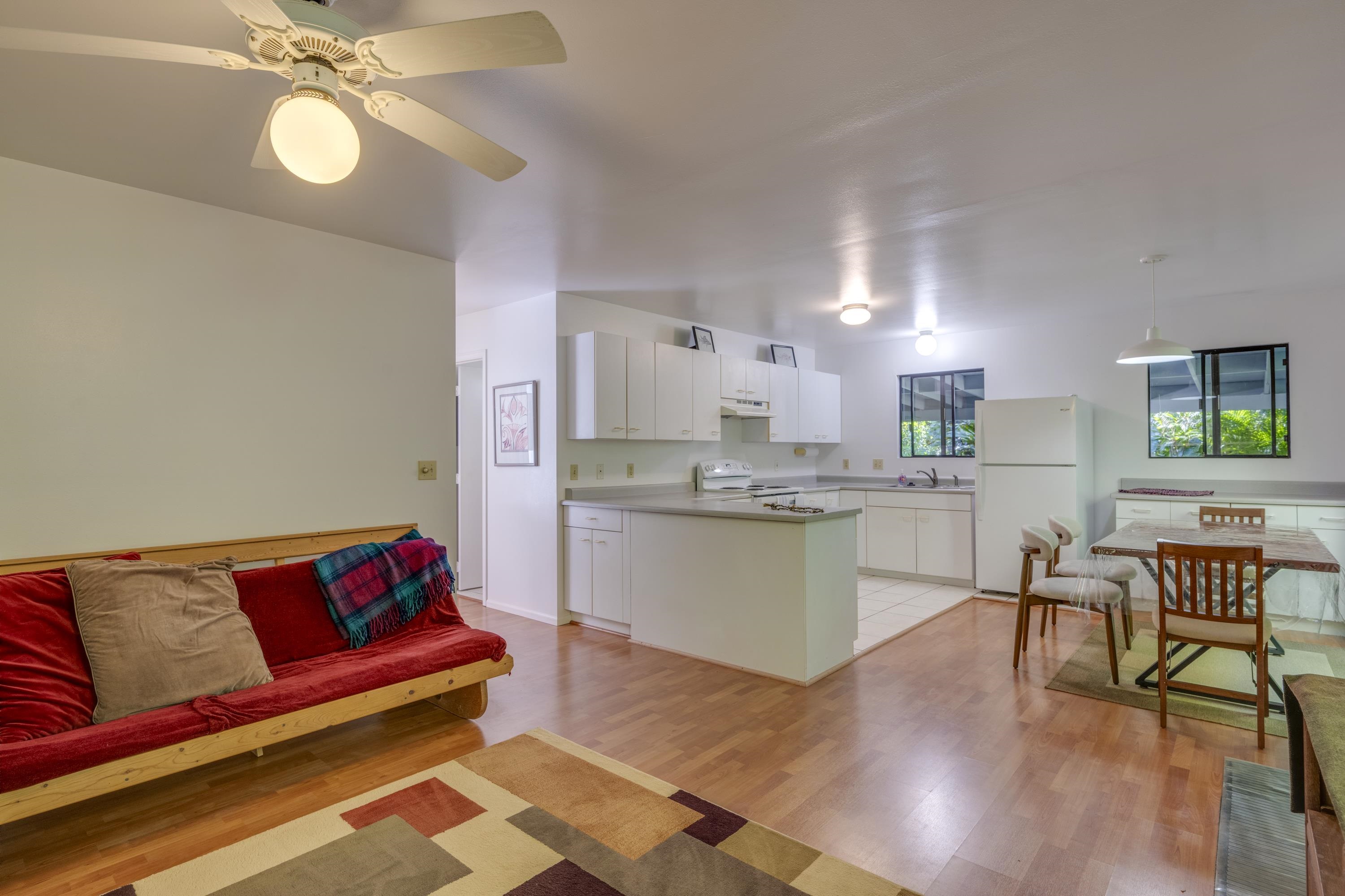 1002 Kauhikoa Road, Unit 2 Haiku, HI 96708 - Photo 16 of 24 a living room with kitchen island furniture and a kitchen view