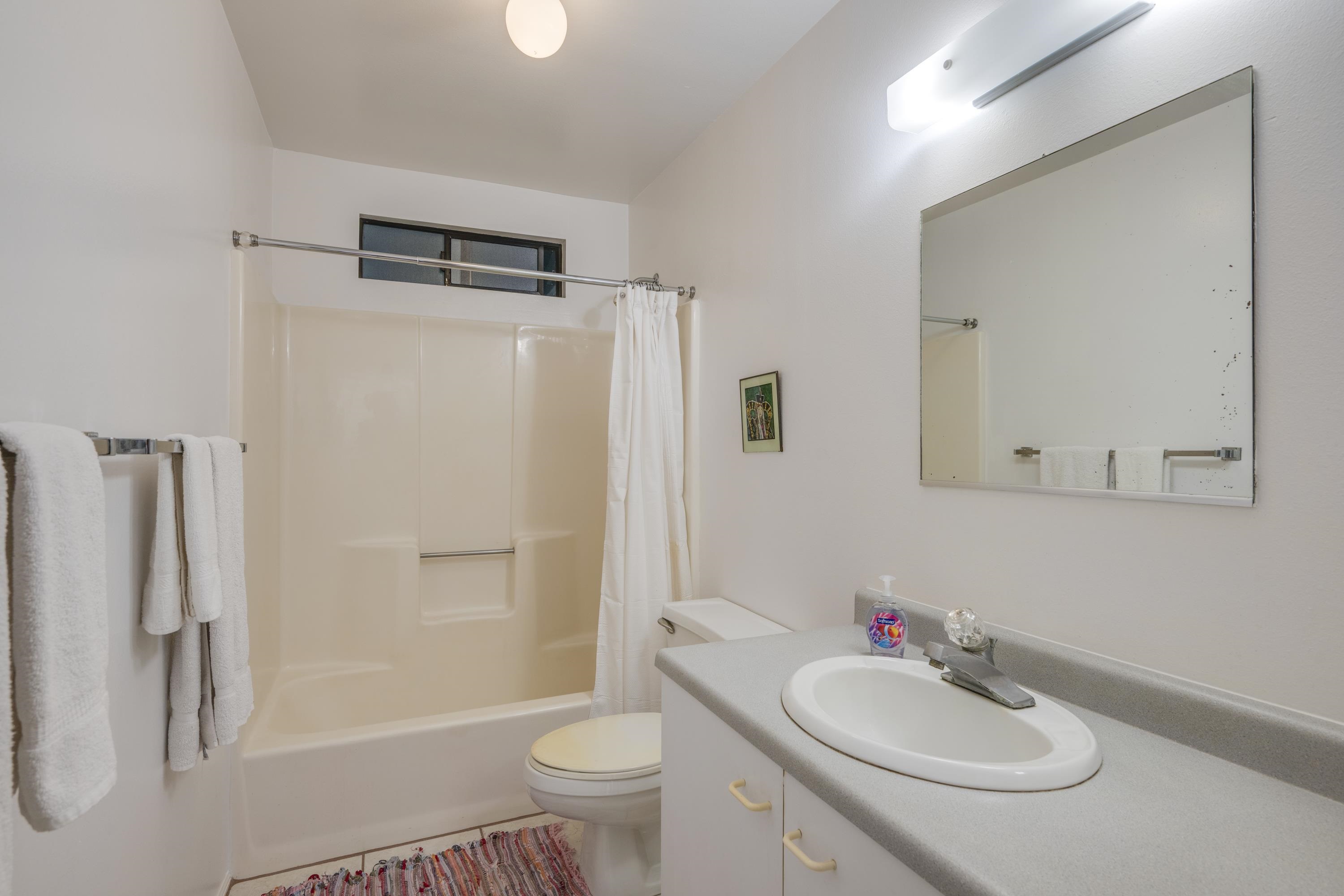 1002 Kauhikoa Road, Unit 2 Haiku, HI 96708 - Photo 21 of 24 a bathroom with a sink toilet tub and shower