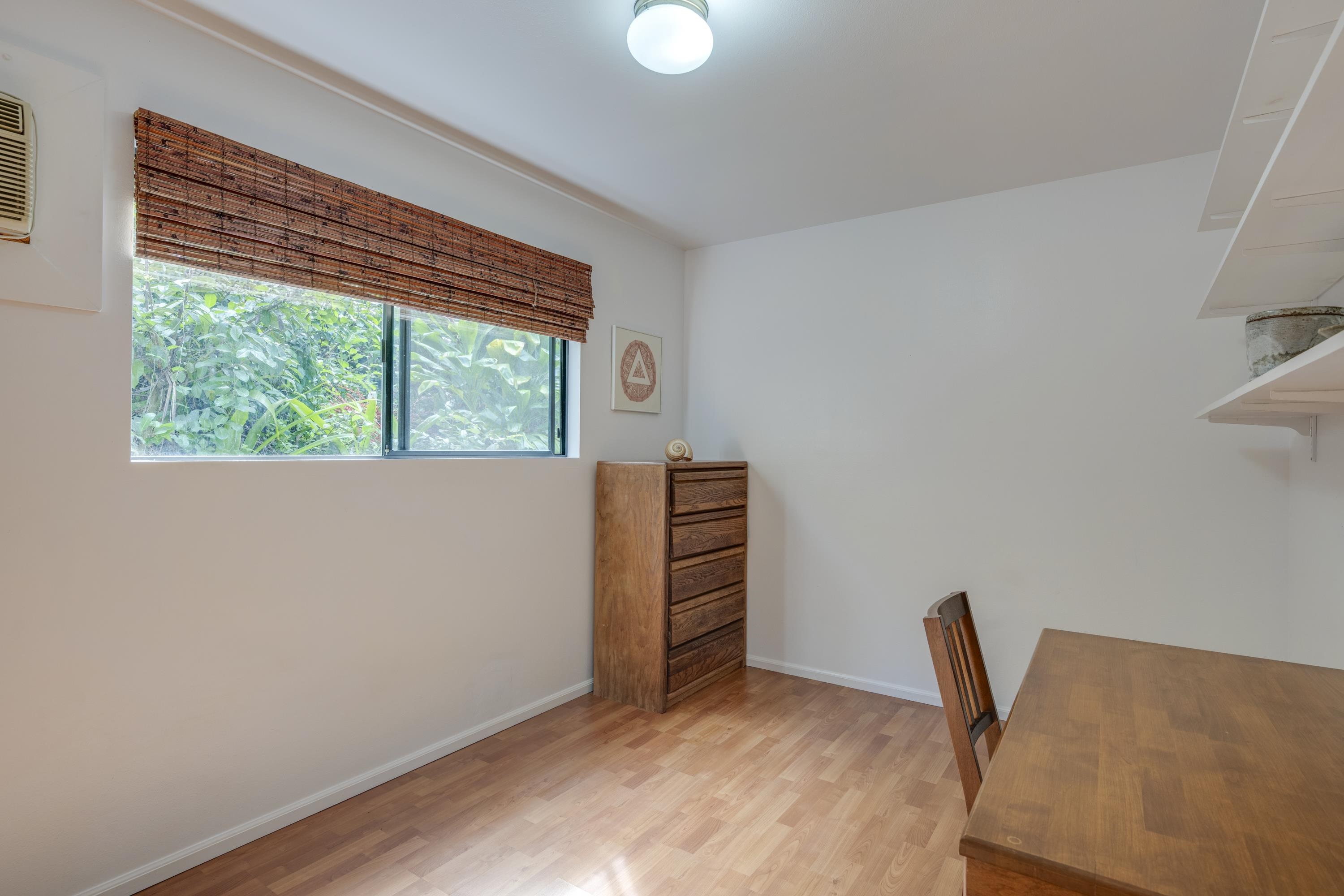 1002 Kauhikoa Road, Unit 2 Haiku, HI 96708 - Photo 23 of 24 a view of a livingroom with wooden floor and a window