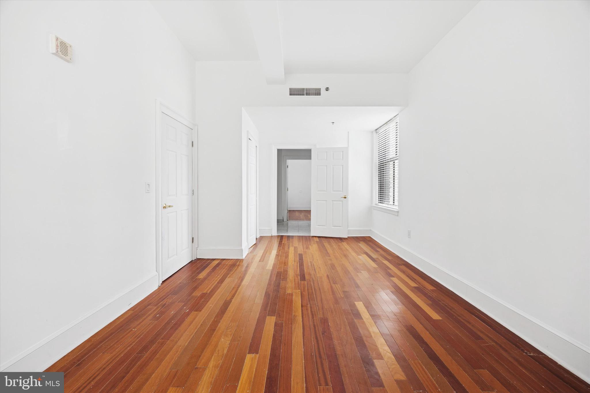 1500 Chestnut Street, Unit 15H Philadelphia, PA 19102 - Photo 12 of 25 a view of a room with wooden floor and white walls