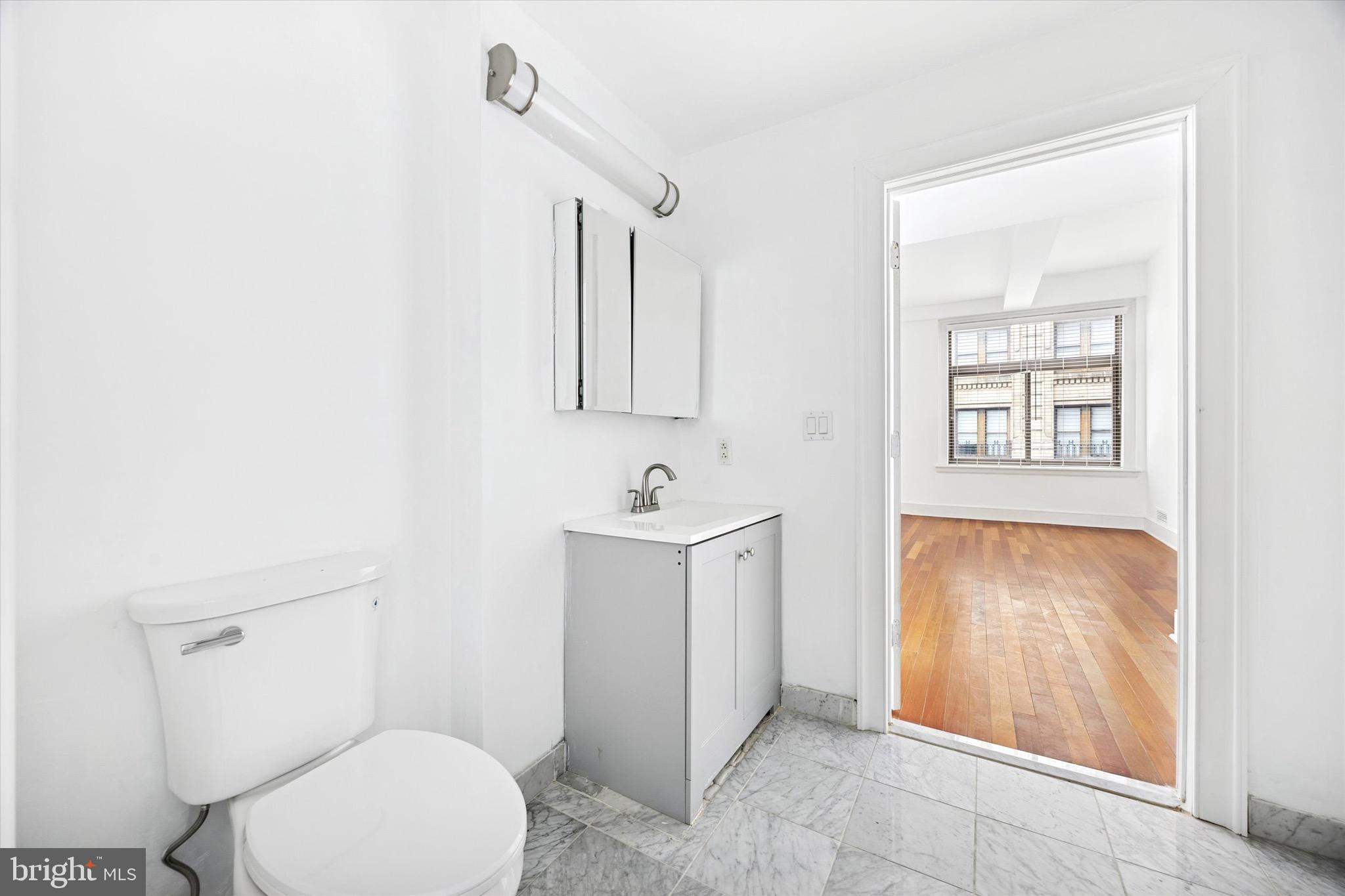 1500 Chestnut Street, Unit 15H Philadelphia, PA 19102 - Photo 18 of 25 a bathroom with a sink toilet and vanity
