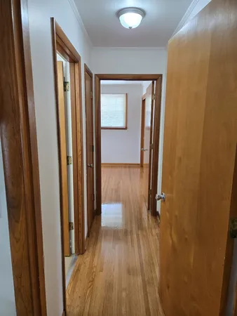 a view of a hallway with wooden floor