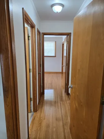 a view of a hallway with wooden floor