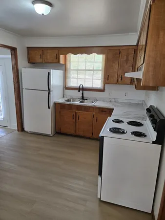a kitchen with stainless steel appliances granite countertop a stove a sink and a refrigerator