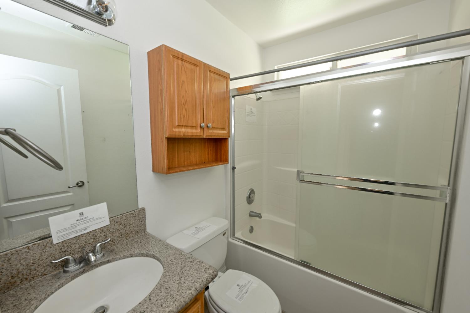 21088 Forest Glen Road Madera, CA 93638 - Photo 12 of 31 a bathroom with a sink toilet and shower