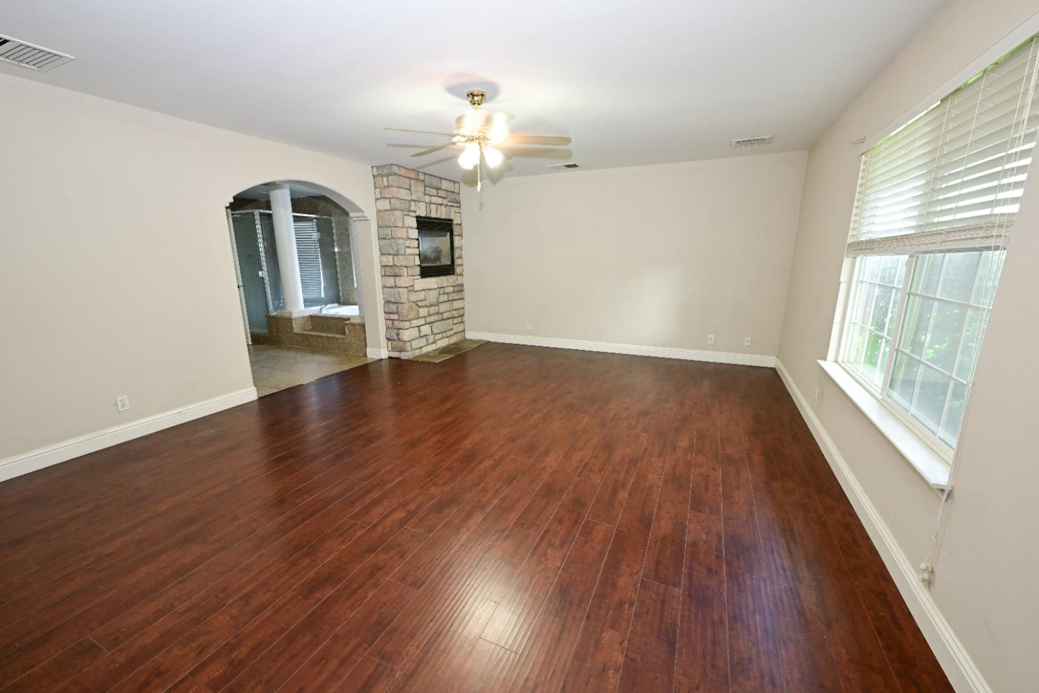 21088 Forest Glen Road Madera, CA 93638 - Photo 17 of 31 an empty room with wooden floor and large windows