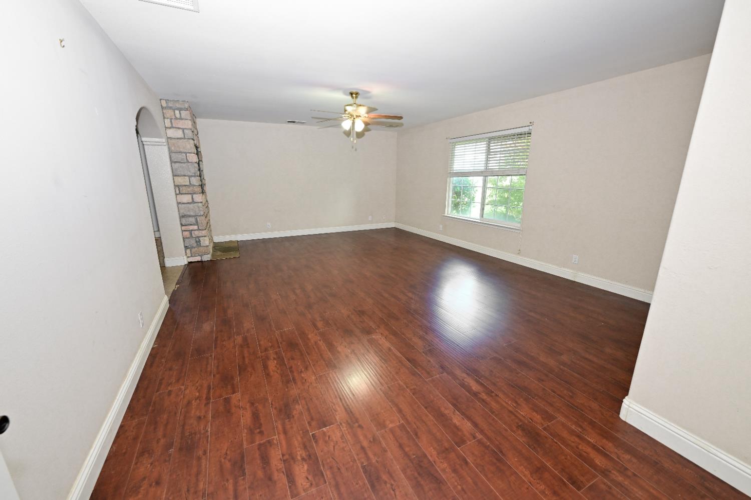 21088 Forest Glen Road Madera, CA 93638 - Photo 18 of 31 an empty room with wooden floor and windows