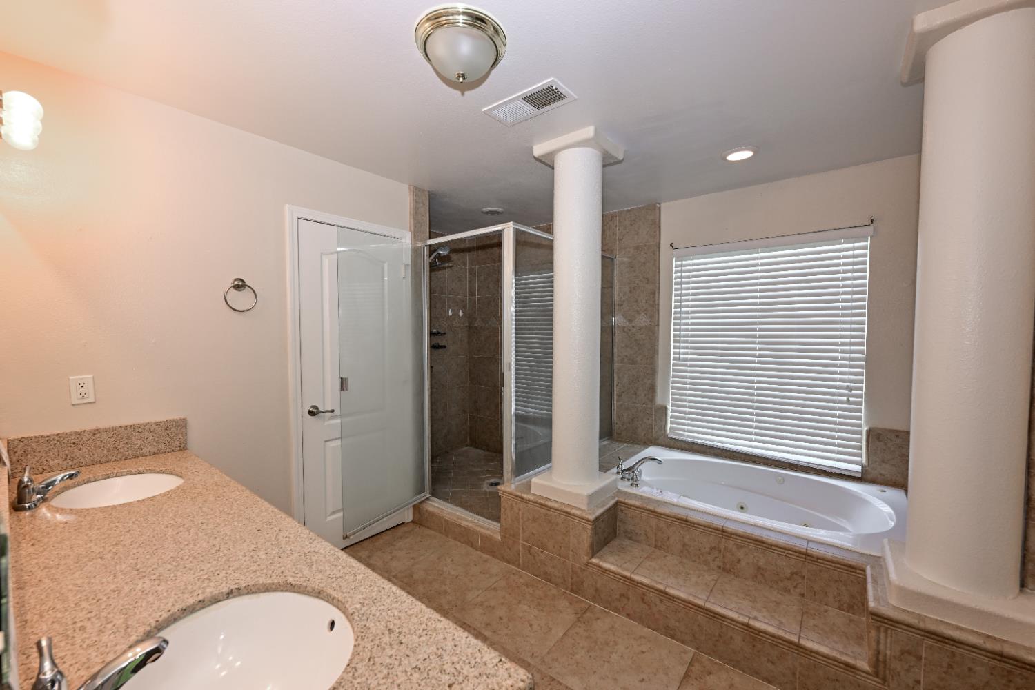 21088 Forest Glen Road Madera, CA 93638 - Photo 21 of 31 a bathroom with a granite countertop sink and a mirror