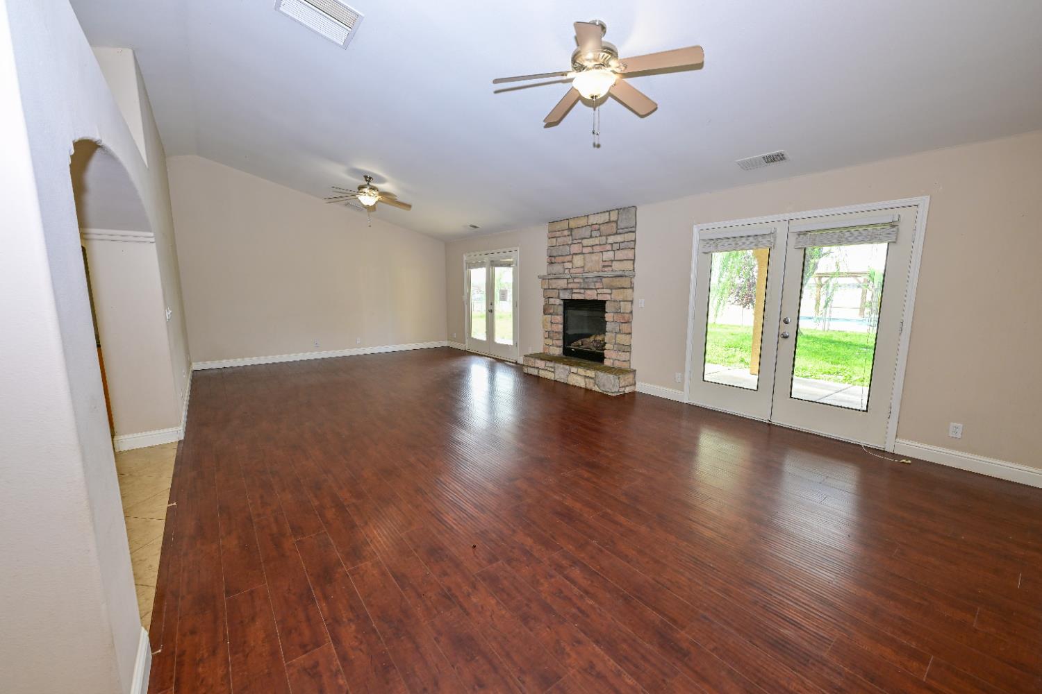 21088 Forest Glen Road Madera, CA 93638 - Photo 5 of 31 wooden floor in an empty room with a window