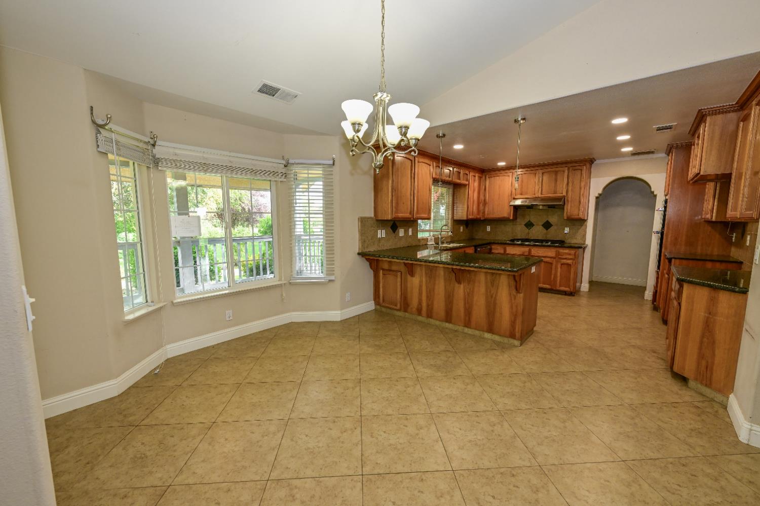 21088 Forest Glen Road Madera, CA 93638 - Photo 8 of 31 a kitchen with stainless steel appliances granite countertop a sink a stove and a refrigerator