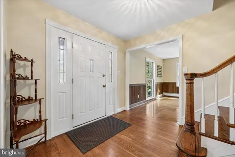 a kitchen with stainless steel appliances granite countertop a sink and dishwasher a refrigerator with wooden cabinets
