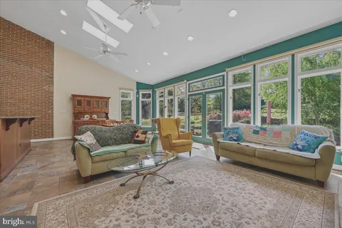 a living room with furniture and a floor to ceiling window