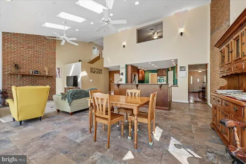 a living room with furniture and a ceiling fan