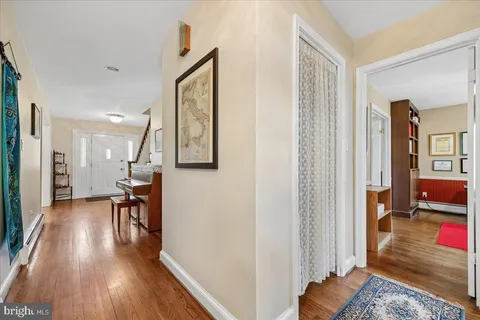 a living room with furniture fireplace and large windows