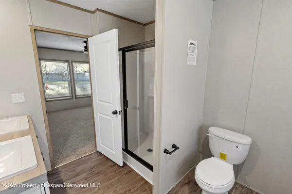 a bathroom with a toilet and a shower