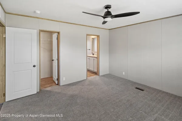 a view of a livingroom with a ceiling fan and window