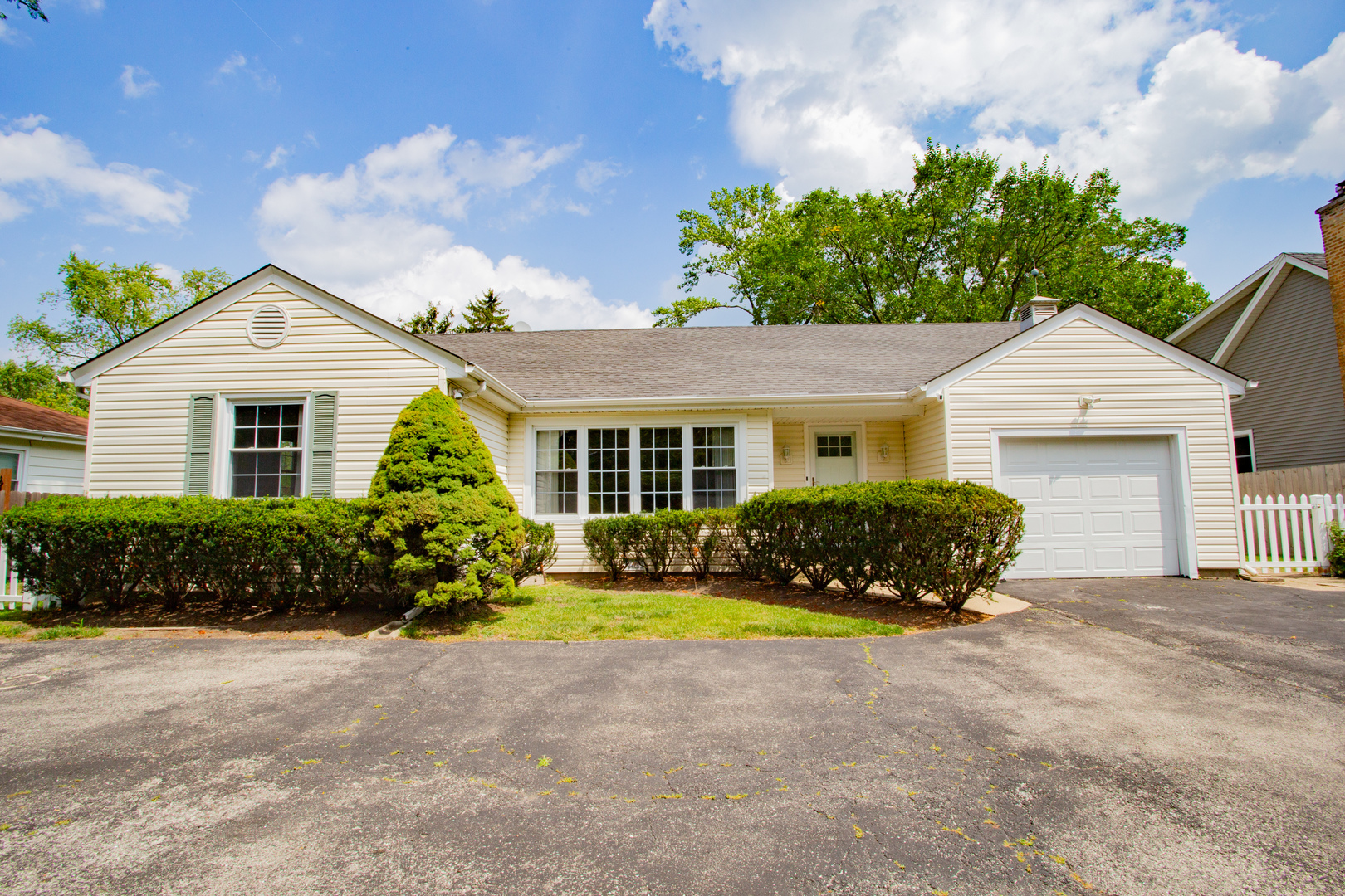 1749 North Happ Road Northbrook, IL 60062 - Photo 1 of 27 a front view of a house with a yard and potted plants