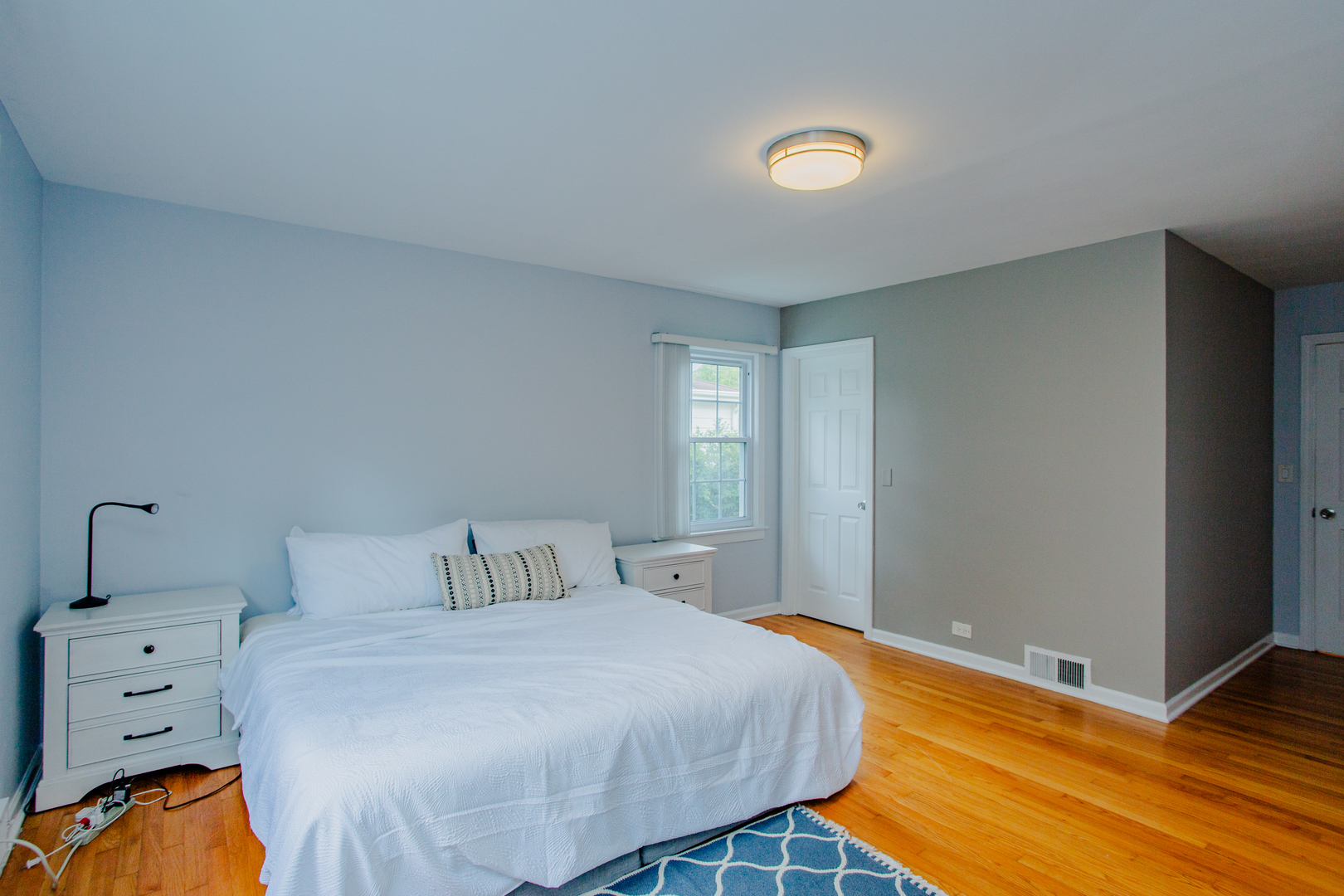 1749 North Happ Road Northbrook, IL 60062 - Photo 11 of 27 a bedroom with a bed and a lamp on the dresser