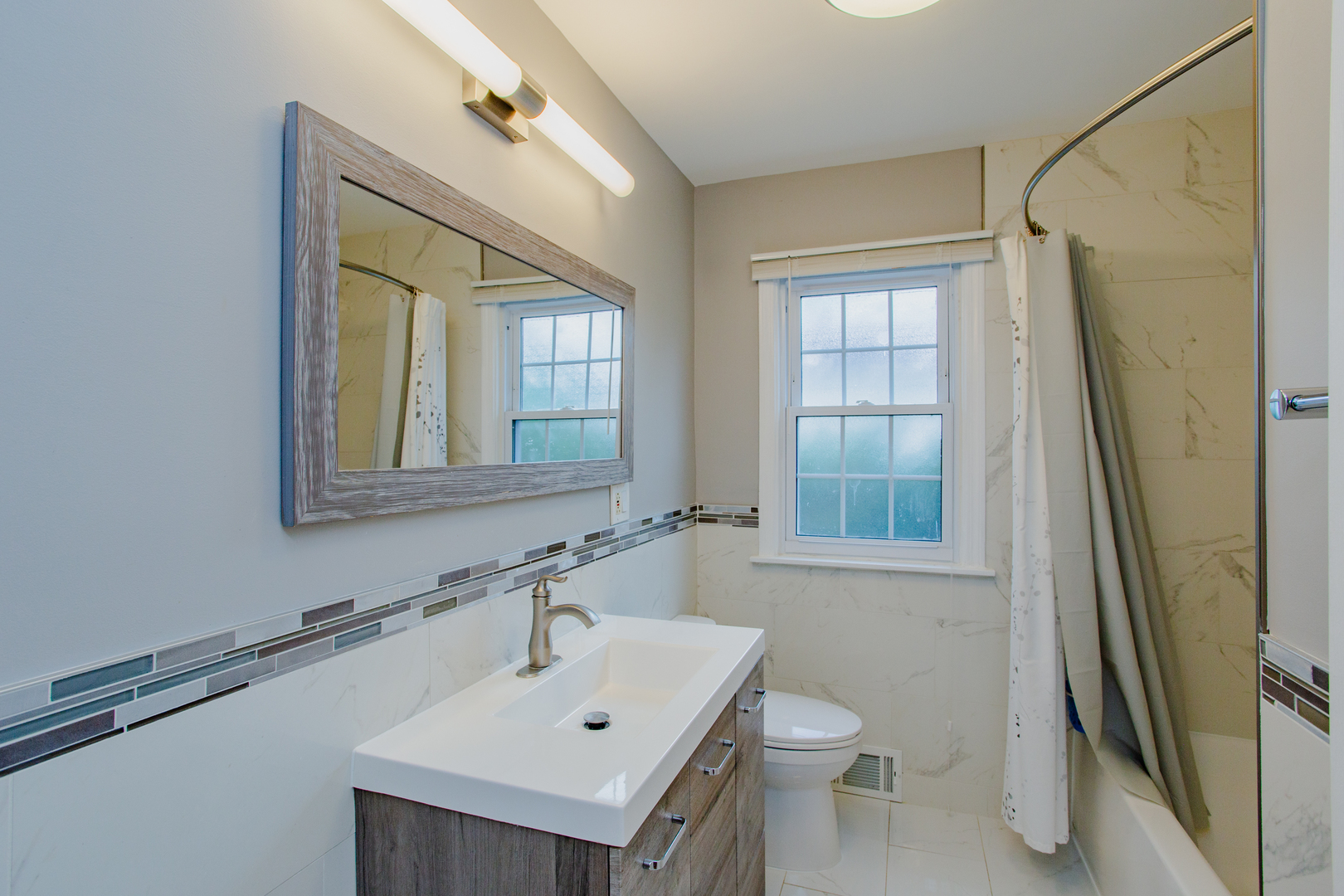 1749 North Happ Road Northbrook, IL 60062 - Photo 20 of 27 a bathroom with a sink toilet and shower