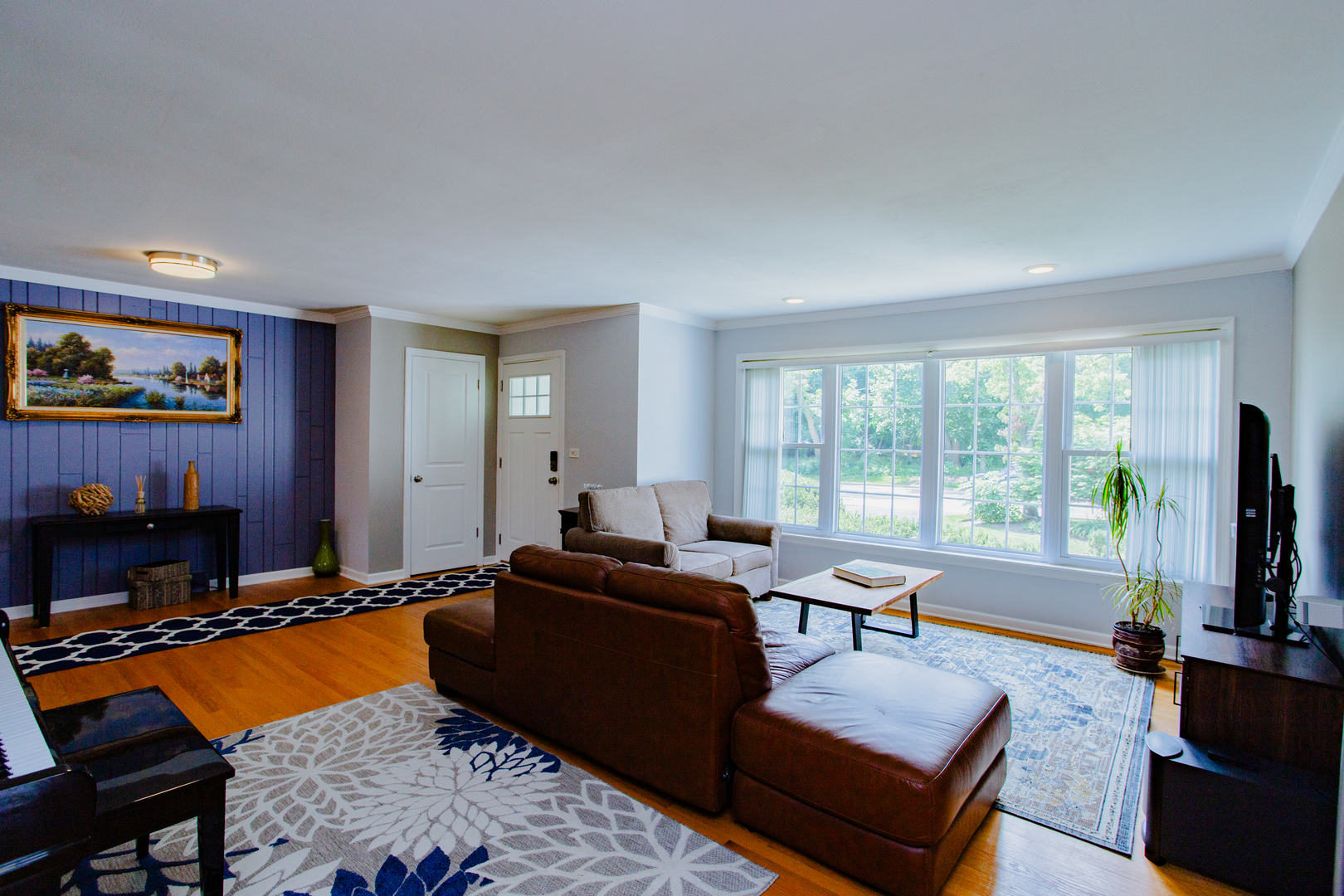 1749 North Happ Road Northbrook, IL 60062 - Photo 4 of 27 a living room with furniture a flat screen tv and a fireplace