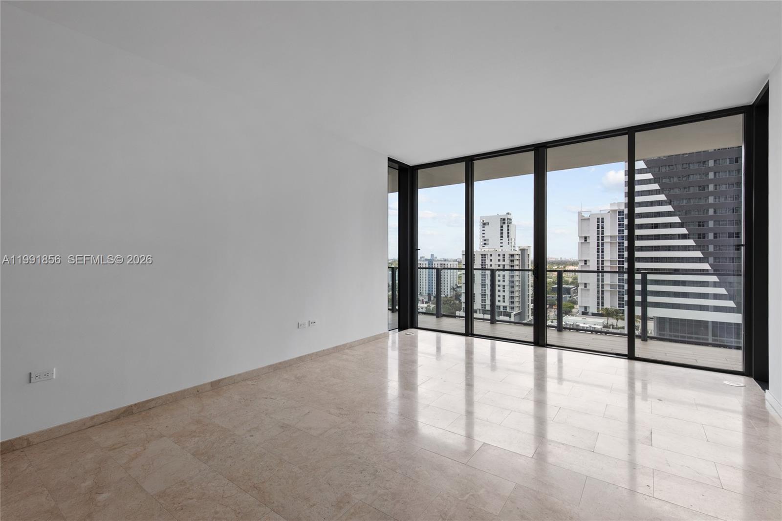 88 Southwest 7th Street, Unit 904 Miami, FL 33130 - Photo 12 of 34 wooden floor in an empty room with a window