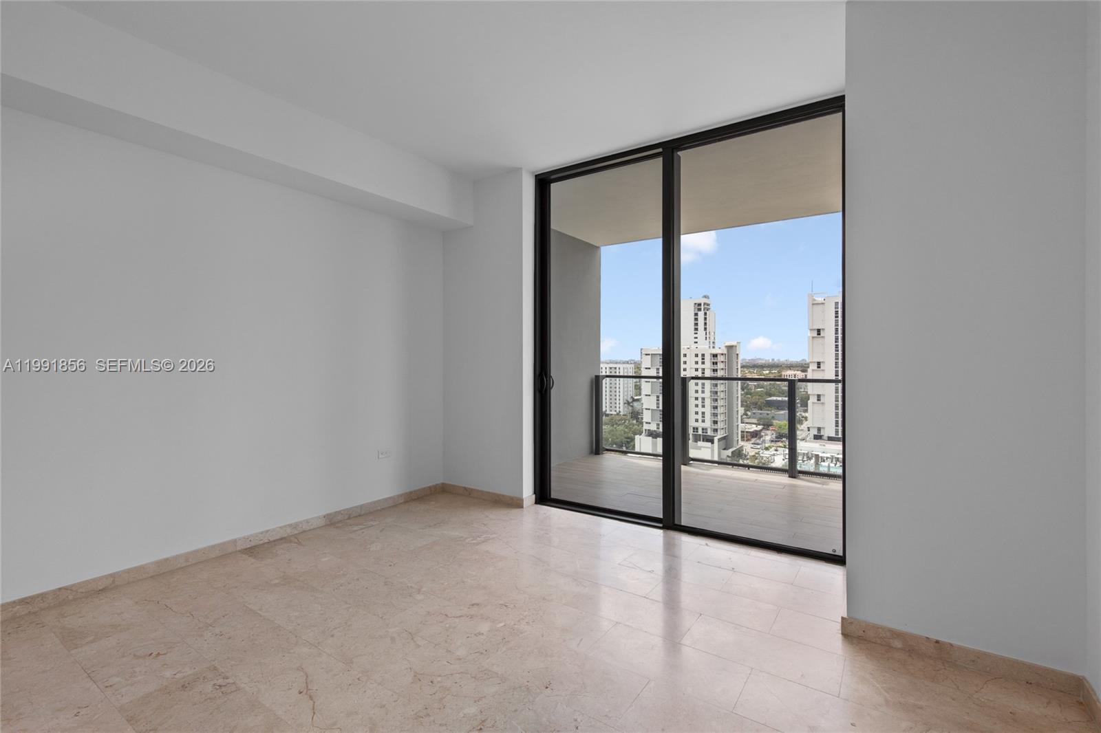 88 Southwest 7th Street, Unit 904 Miami, FL 33130 - Photo 17 of 34 an empty room with sliding glass door and glass door