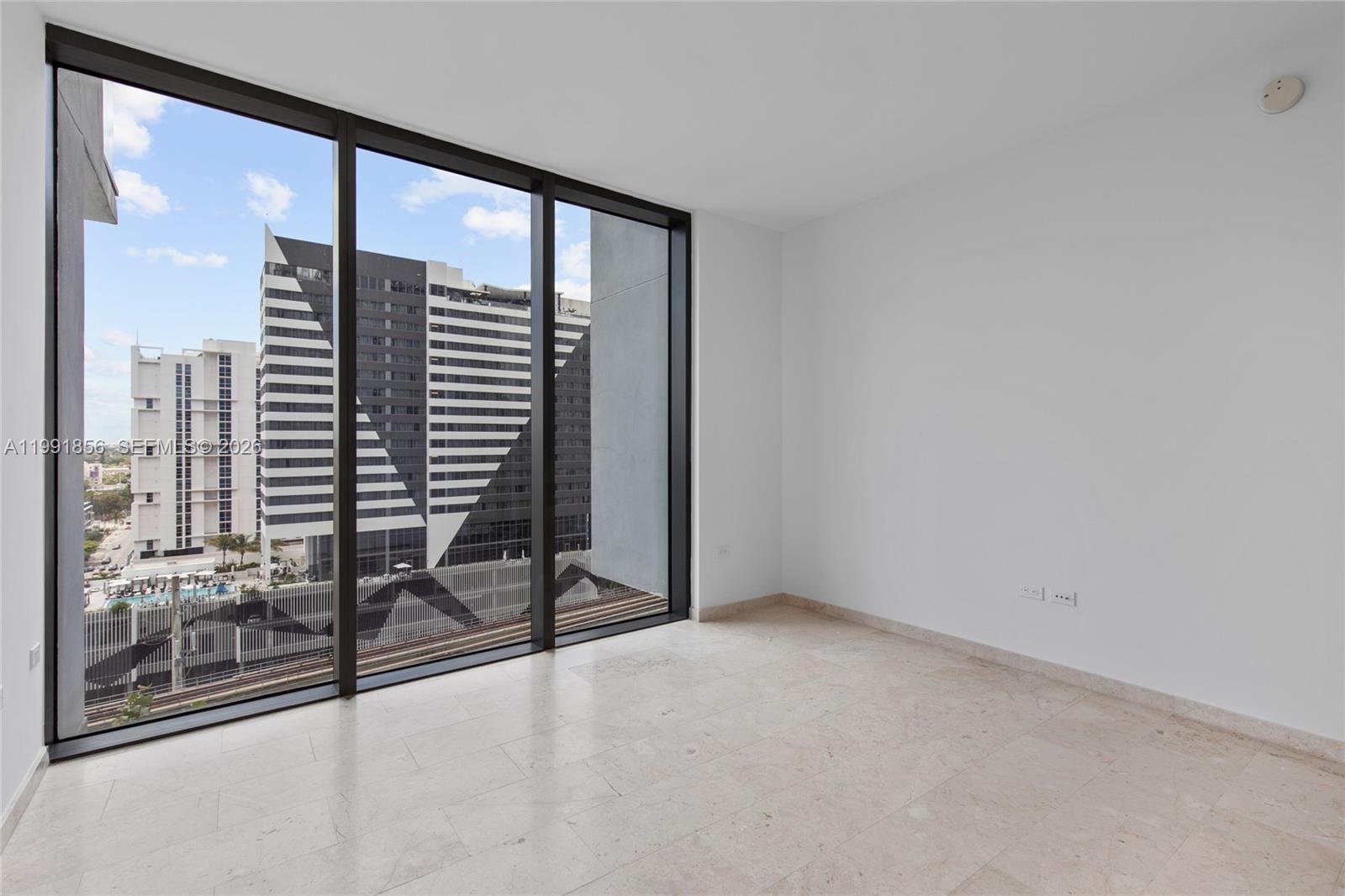 88 Southwest 7th Street, Unit 904 Miami, FL 33130 - Photo 19 of 34 a view of an empty room and window