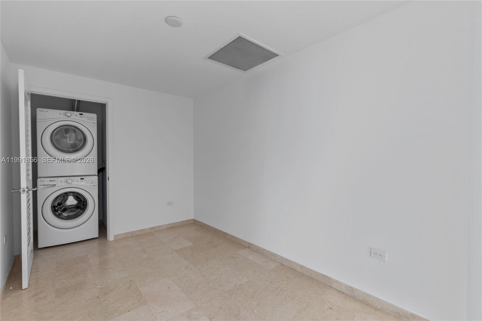 88 Southwest 7th Street, Unit 904 Miami, FL 33130 - Photo 23 of 34 a view of a storage and utility room with washer and dryer