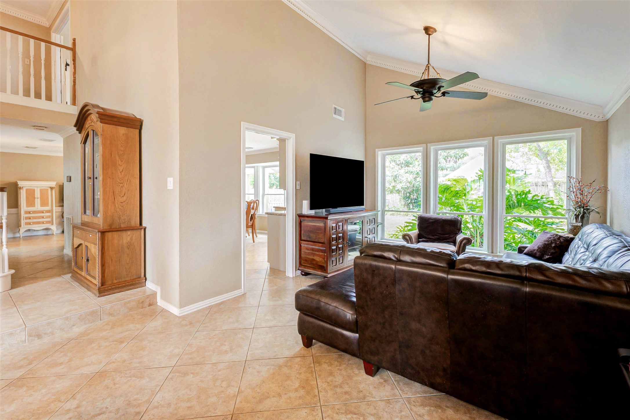 15811 Spring Forest Drive Houston, TX 77059 - Photo 6 of 27 This inviting living space boasts high ceilings and abundant natural light, creating an open and airy atmosphere perfect for relaxation and entertaining.
