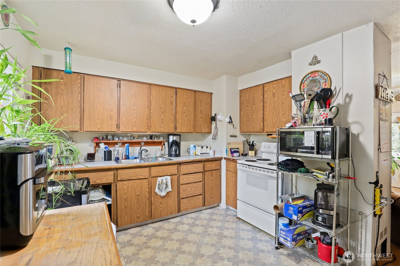 2853 Clare Avenue Bremerton, WA 98310 - Photo 8 of 21 a kitchen with stainless steel appliances a stove a sink and a refrigerator
