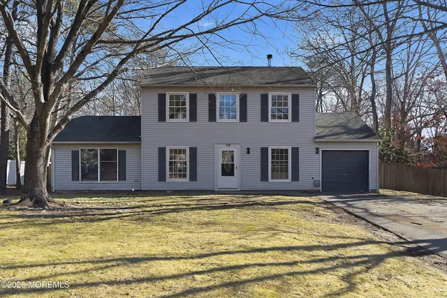 a house view with swimming pool in front of it