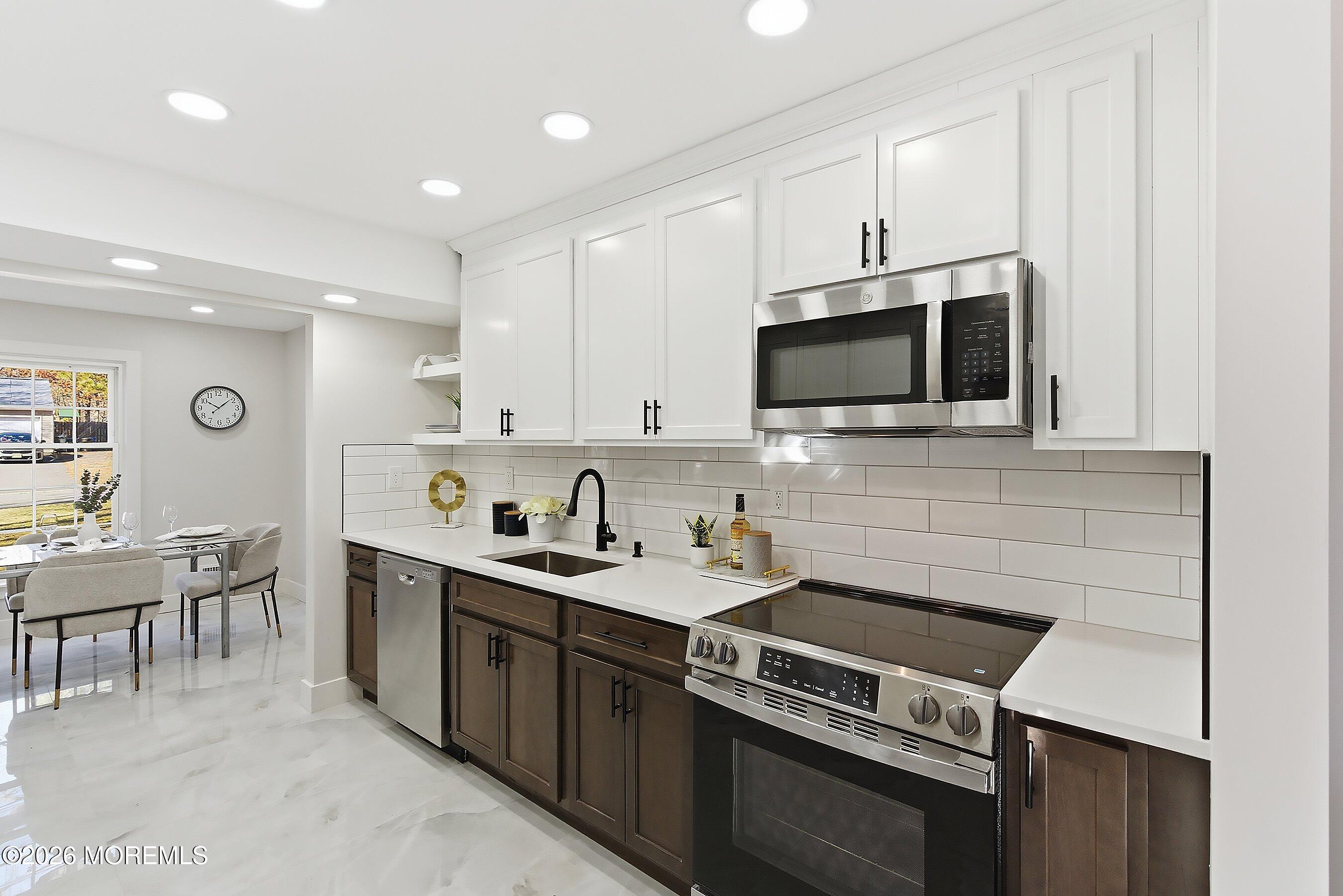 16 6th Street Barnegat, NJ 08005 - Photo 11 of 36 a kitchen with a sink stove and microwave