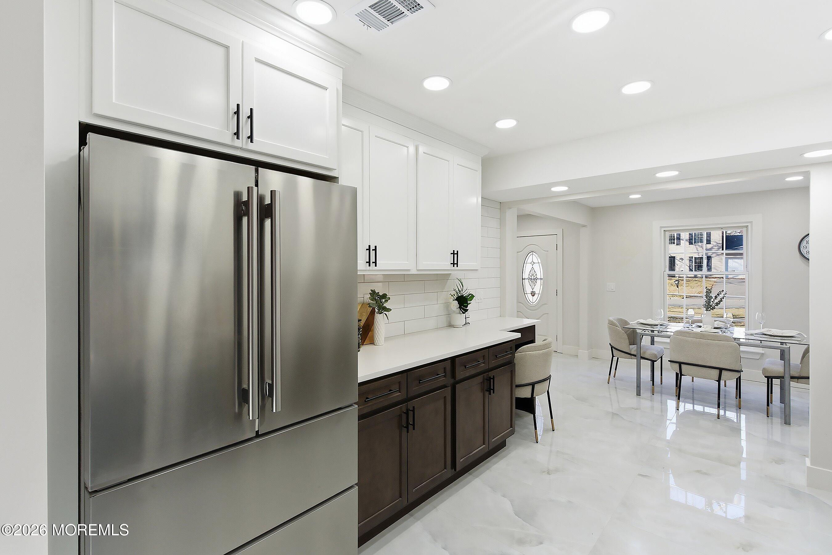 16 6th Street Barnegat, NJ 08005 - Photo 12 of 36 a kitchen with kitchen island a counter top space cabinets a sink stainless steel appliances and cabinets