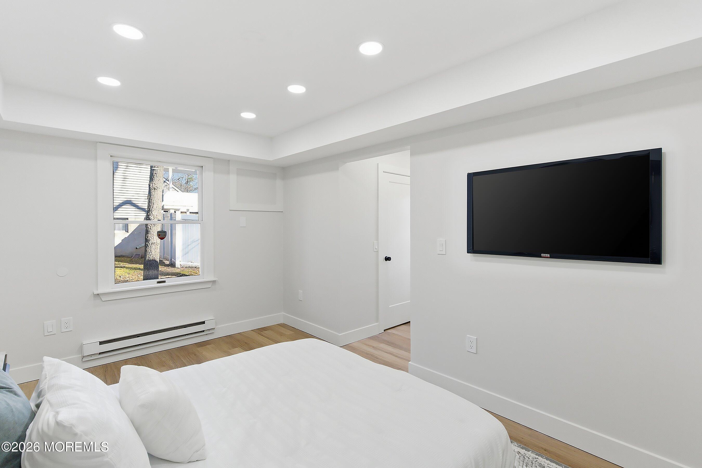 16 6th Street Barnegat, NJ 08005 - Photo 19 of 36 a bedroom with a bed and a flat screen tv