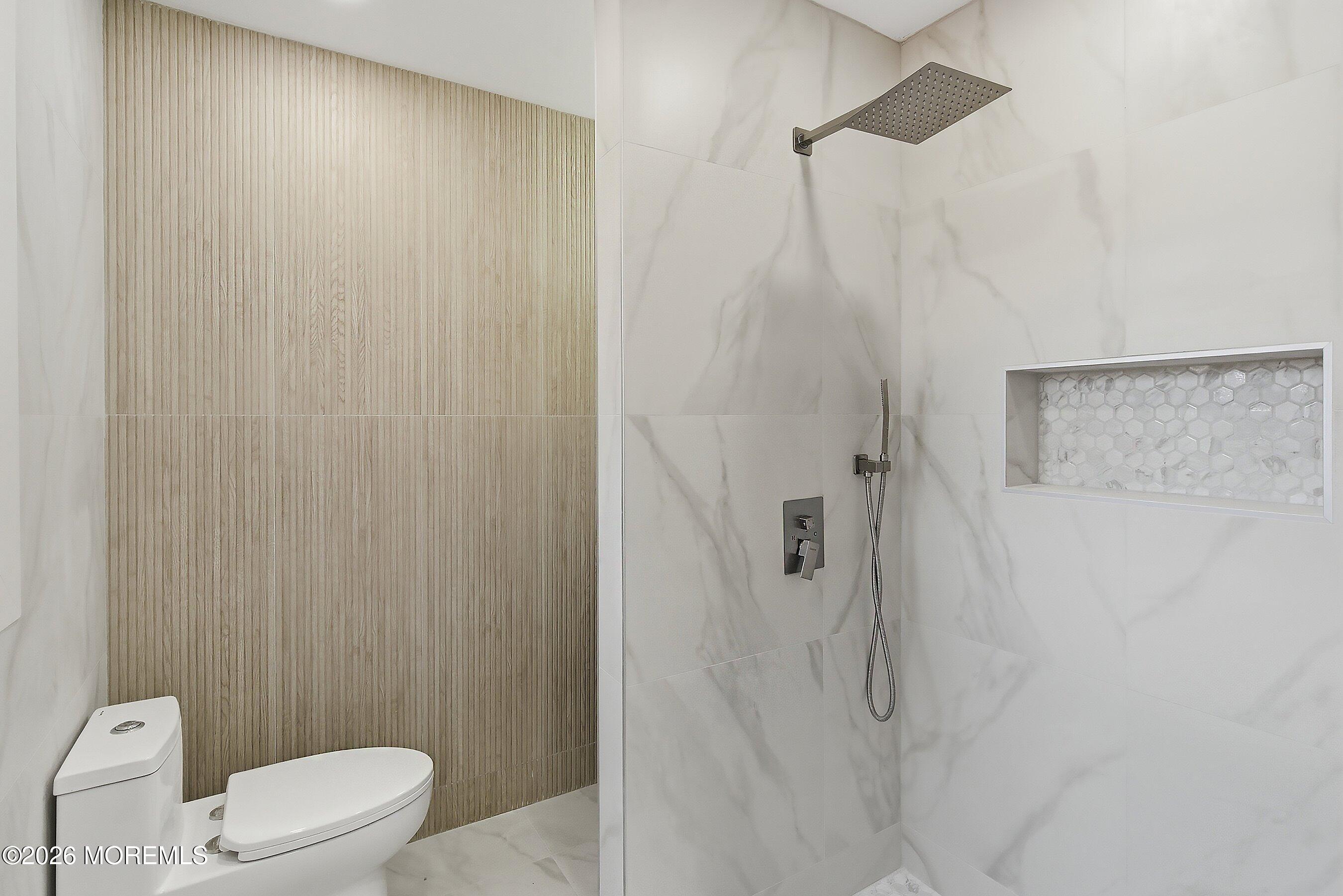 16 6th Street Barnegat, NJ 08005 - Photo 20 of 36 a white toilet sitting next to a shower curtain