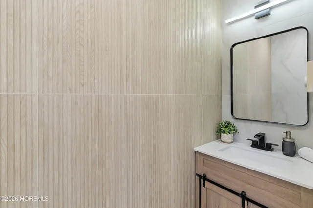 a bathroom with a glass shower door