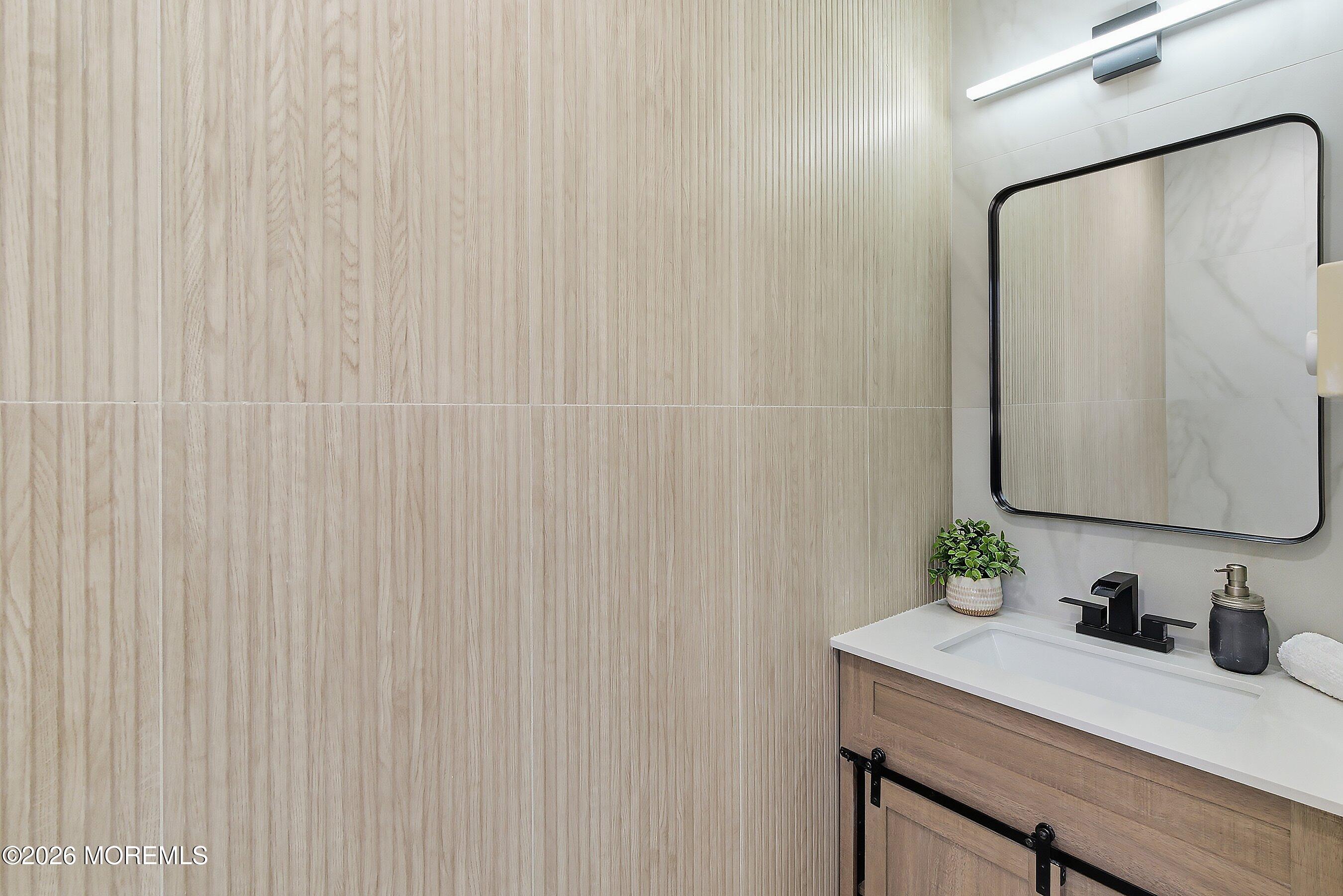 16 6th Street Barnegat, NJ 08005 - Photo 22 of 36 a bathroom with a granite countertop sink and a mirror