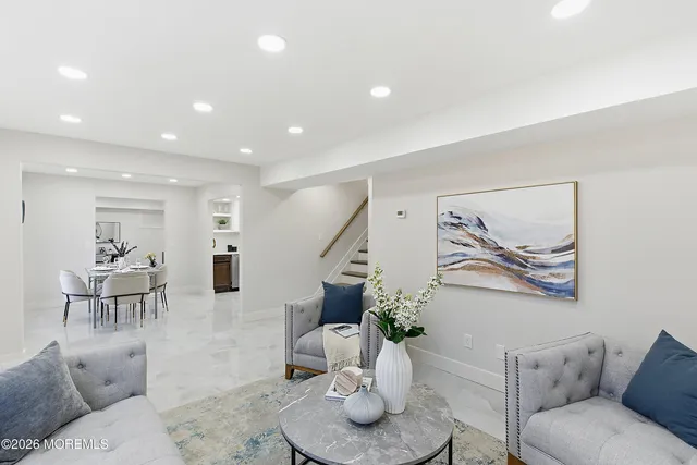 a living room with furniture and a painting on the wall