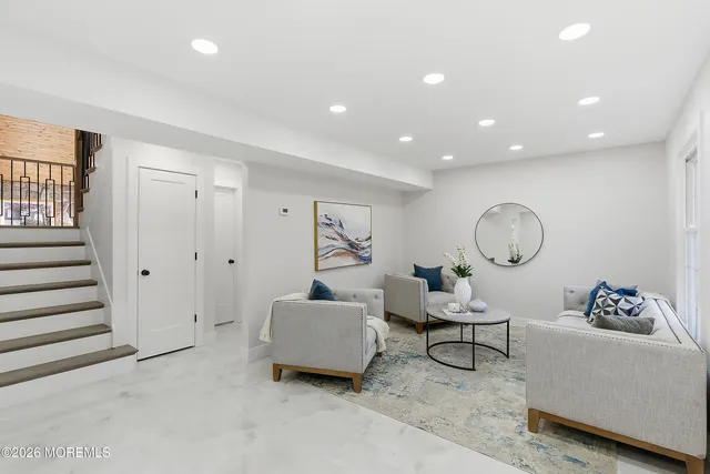 a bathroom with a toilet sink vanity and mirror