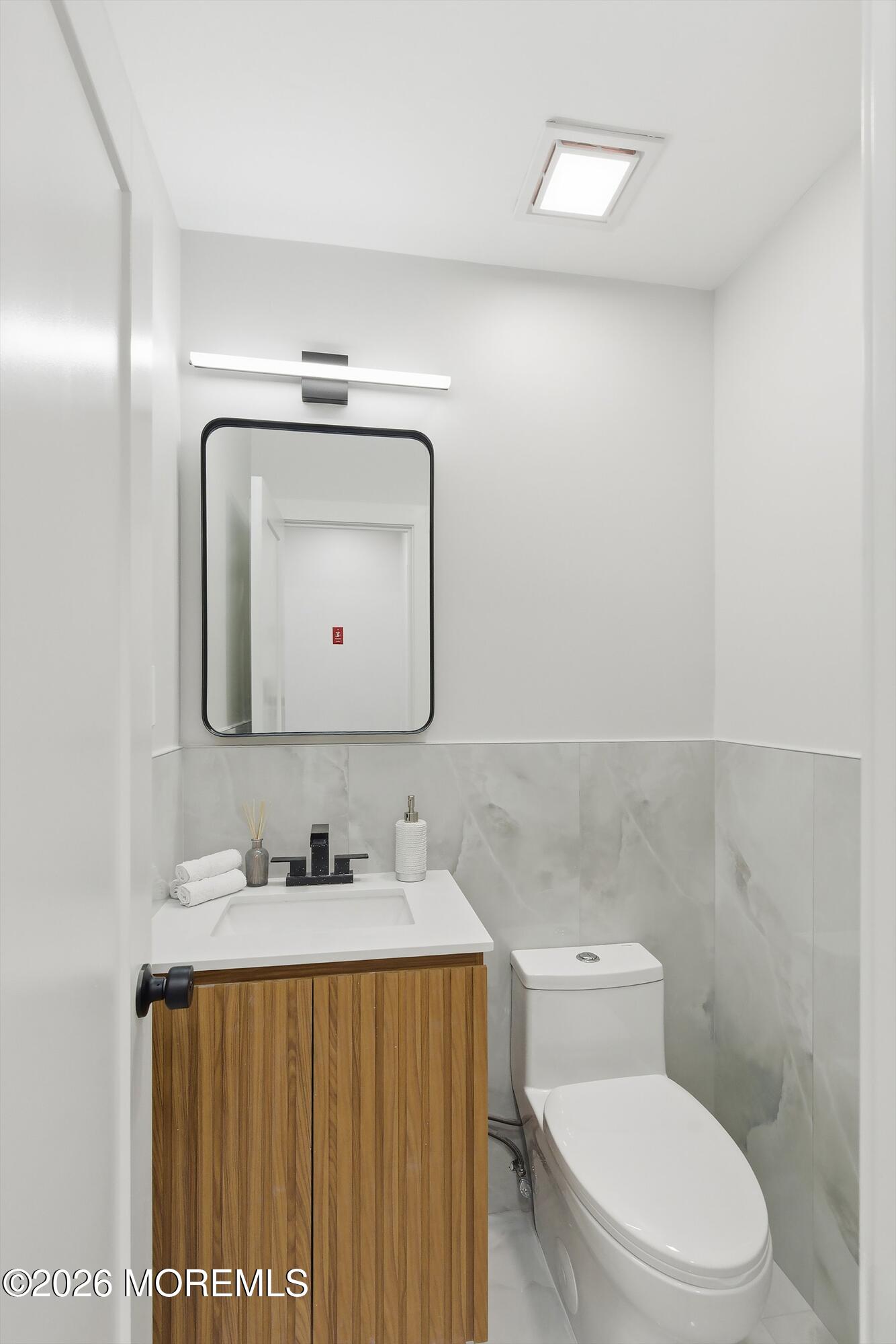 16 6th Street Barnegat, NJ 08005 - Photo 6 of 36 a bathroom with a toilet sink vanity and mirror