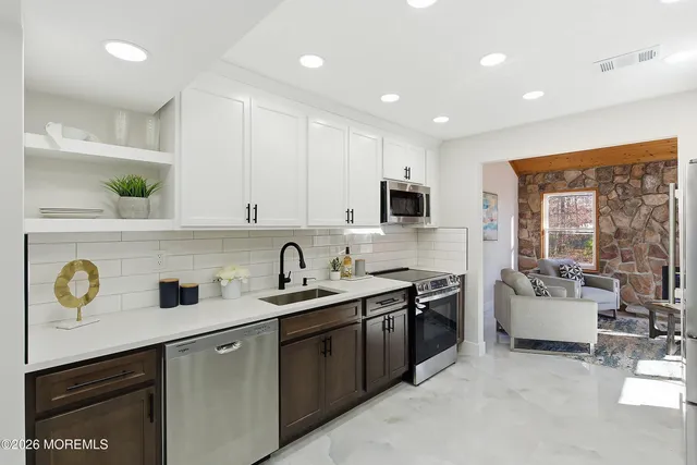 a kitchen with a sink stove and microwave
