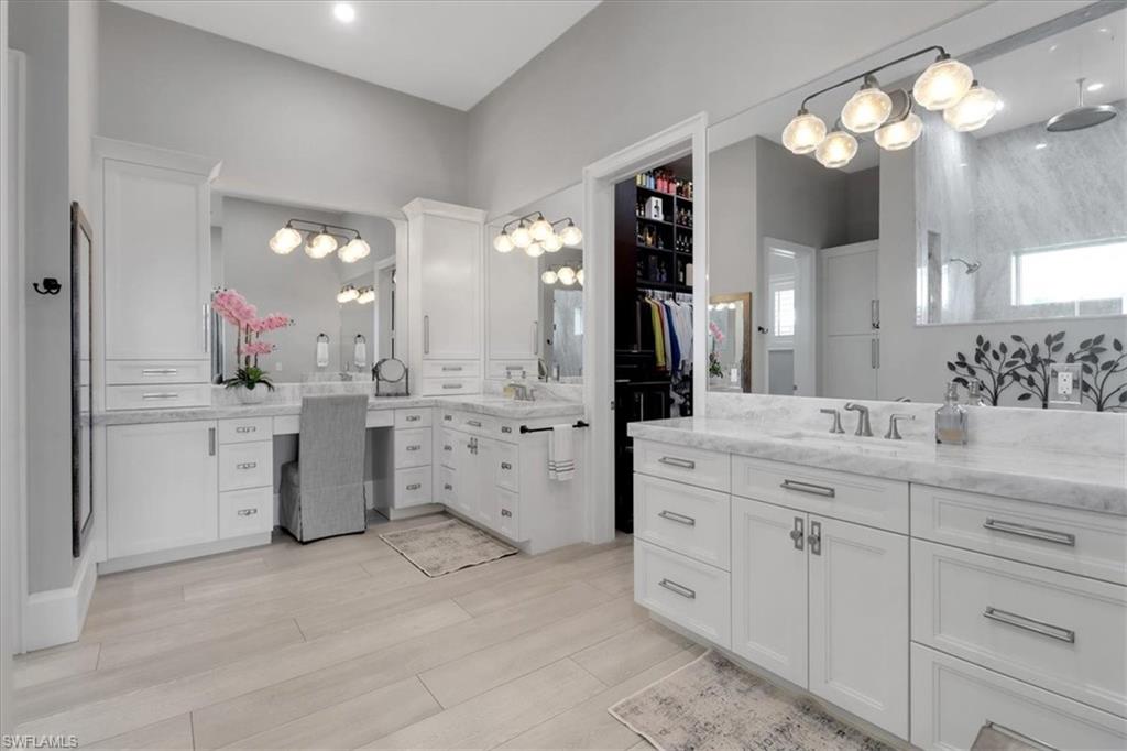 1425 Crayton Road Naples, FL 34102 - Photo 11 of 31 Bathroom featuring a shower, hardwood / wood-style flooring, and vanity