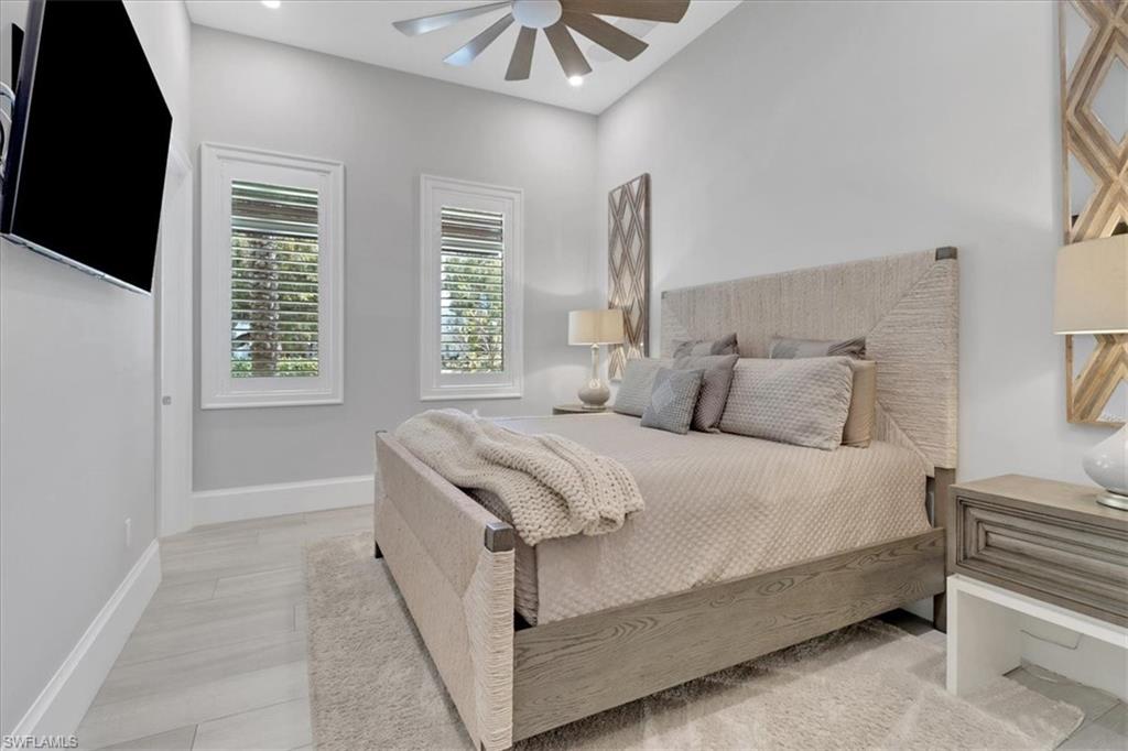 1425 Crayton Road Naples, FL 34102 - Photo 13 of 31 Bedroom with light hardwood / wood-style floors and ceiling fan