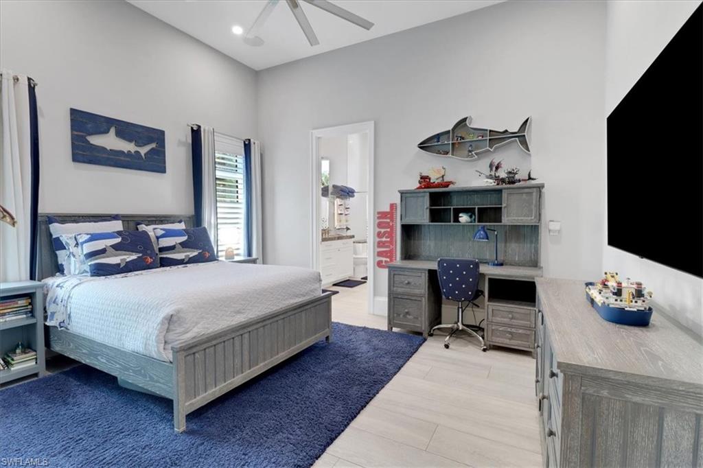 1425 Crayton Road Naples, FL 34102 - Photo 15 of 31 Bedroom with ensuite bathroom, light wood-type flooring, and ceiling fan