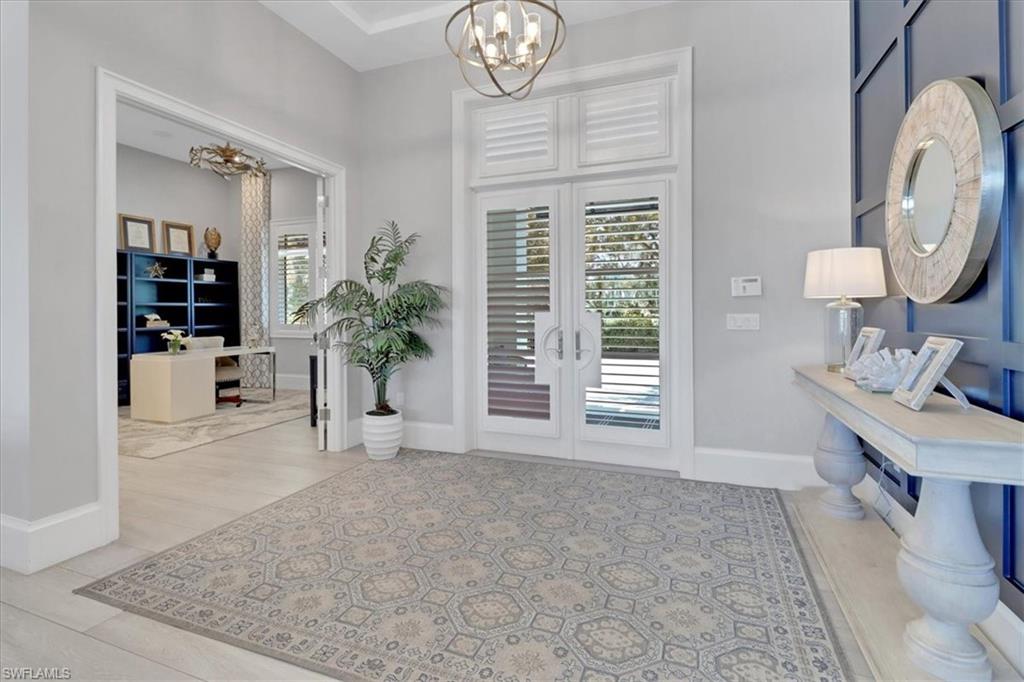 1425 Crayton Road Naples, FL 34102 - Photo 2 of 31 Foyer entrance with a chandelier and french doors