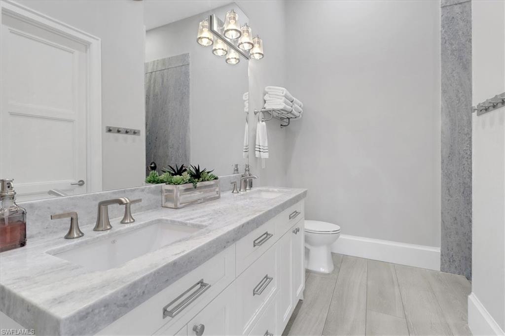 1425 Crayton Road Naples, FL 34102 - Photo 21 of 31 Bathroom featuring toilet and vanity