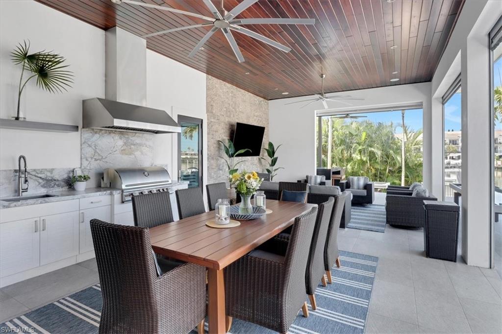 1425 Crayton Road Naples, FL 34102 - Photo 24 of 31 Dining space featuring sink, ceiling fan, and wooden ceiling