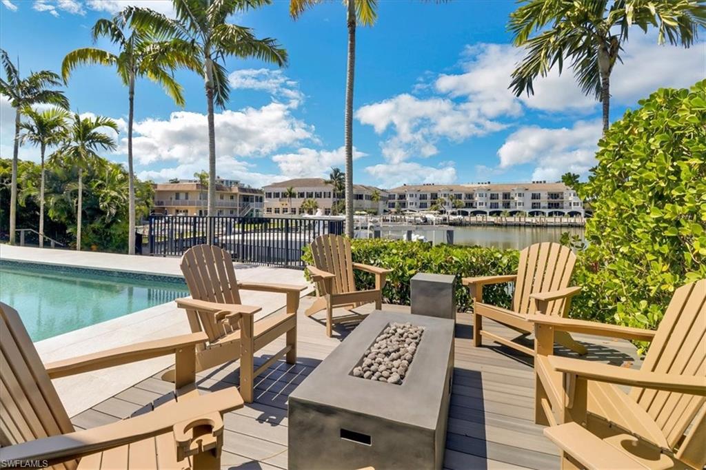 1425 Crayton Road Naples, FL 34102 - Photo 28 of 31 View of swimming pool with a deck with water view